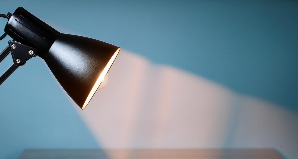 Adjustable reading lamp with flexible neck and head, positioned for optimal light direction