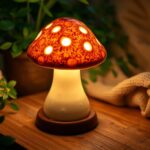 Charming ceramic mushroom lamp glowing softly, cozy ambiance, warm light illuminating a rustic wooden table, intricate glaze details, whimsical design, surrounded by lush greenery and soft fabrics, inviting atmosphere.